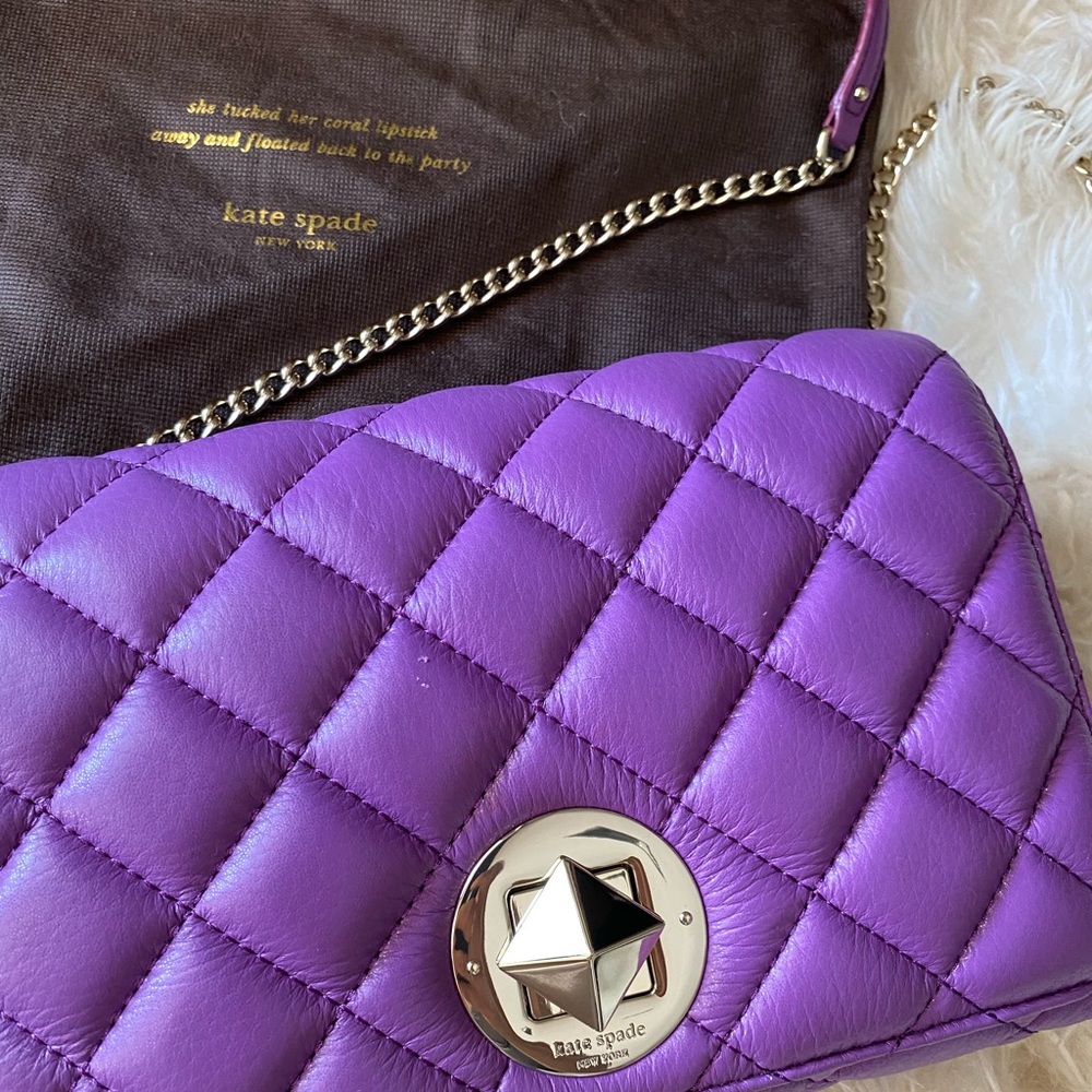 Quilted Kate Spade purse with silver details.